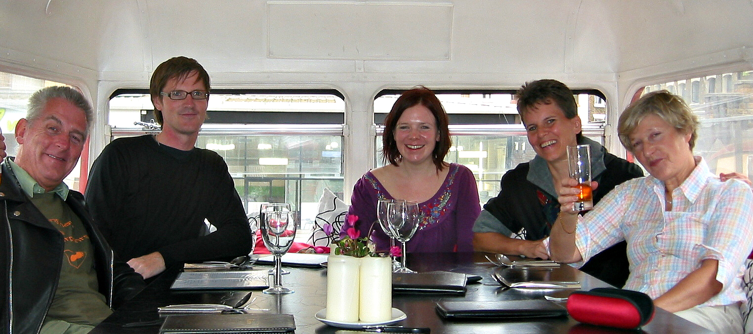 George D Rodger (L), in London’s Rootmaster “bustaurant” with long-term Vegan Society members Dean Bracher, Caroline McAleese, Lee Hall, and Patricia Tricker. Are those Virginian Stock flowers on the table?